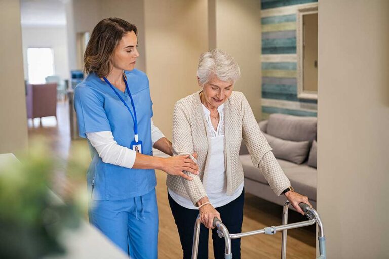 Caregiver reviewing a personalized care plan with an older adult at a dining table.